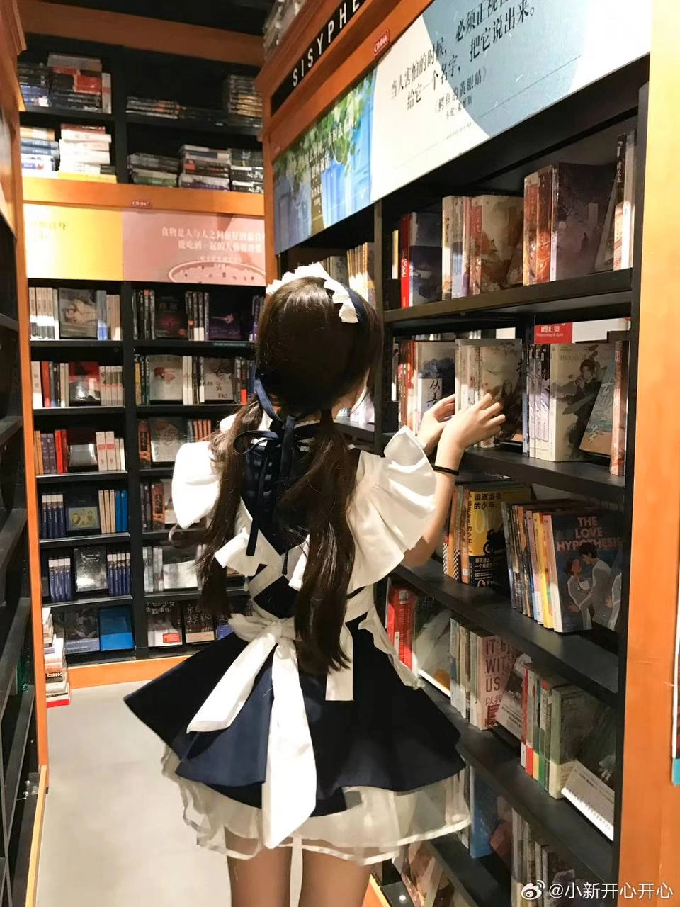 穿着女仆的服装的女人正在读一本书。