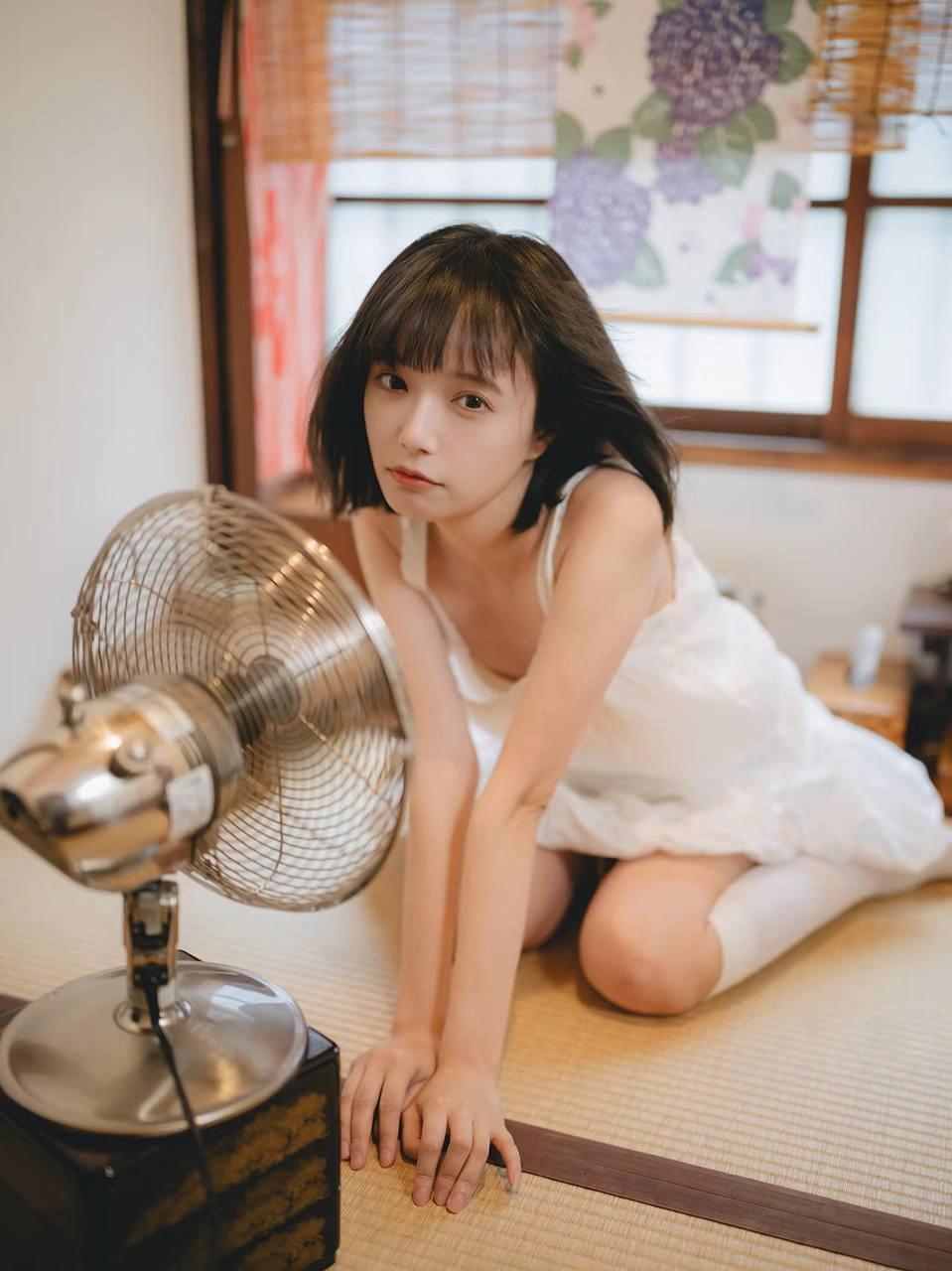 穿着白色衣服的女人坐在楼梯上。