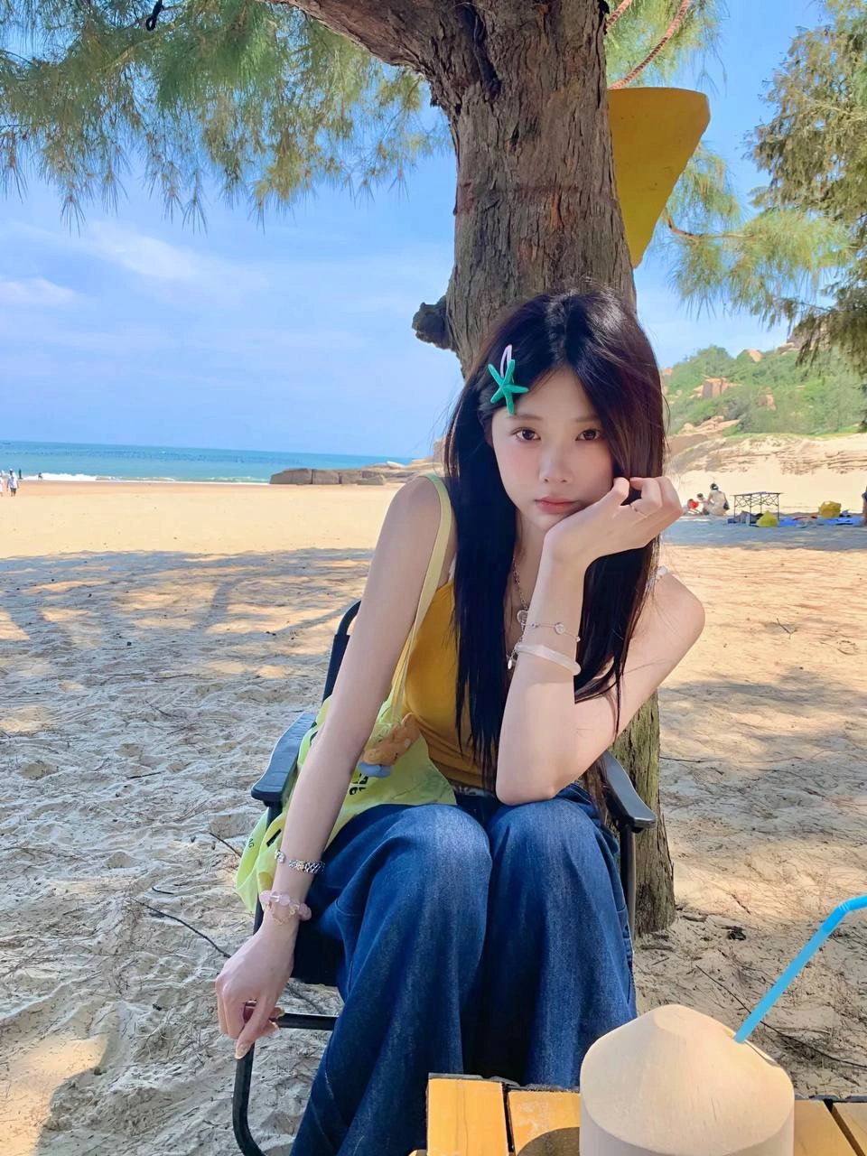 女人拿着一个椰子饮料与一根子。