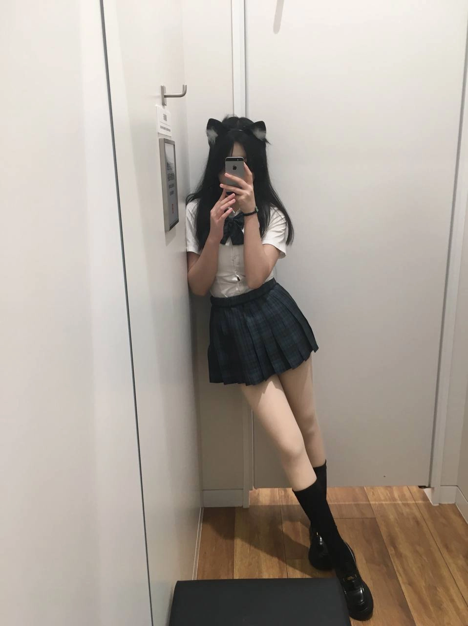 一位穿着白色衬衫和黑色衬衫的女人坐在椅子上。