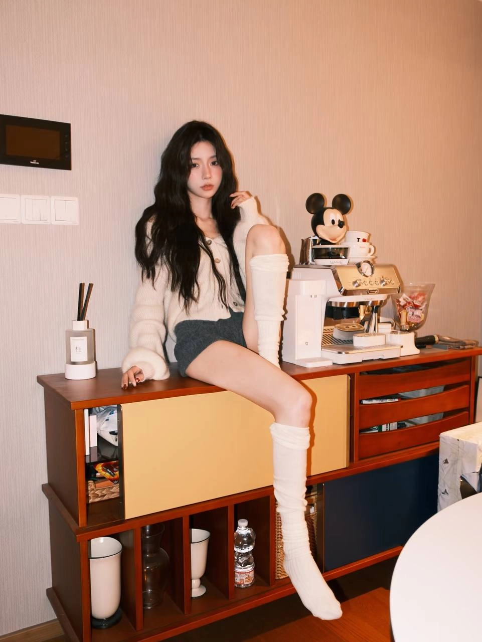 穿白色衬衫和黑色短裤的女人坐在一张桌子上。