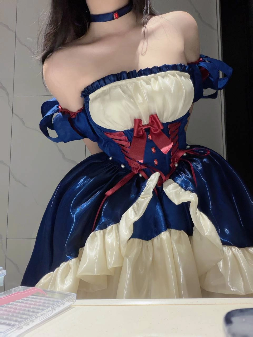 穿着蓝色裙子的女人,有一条红色的弓。